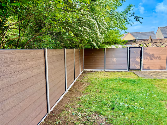 Woodgrain composite fence with matching garden gate