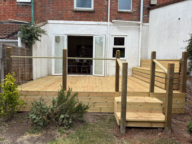 Raised timber deck with built-in bench storage and wire balustrade