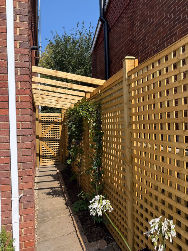 Custom timber trellis, matching gate and lean-to pergola installed beside a house
