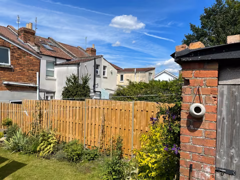 Hit-and-miss timber fencing with olive-green DuraPost supports in a Fishponds garden