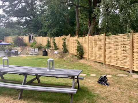 Long run of woven timber fencing installed around a large Bristol garden